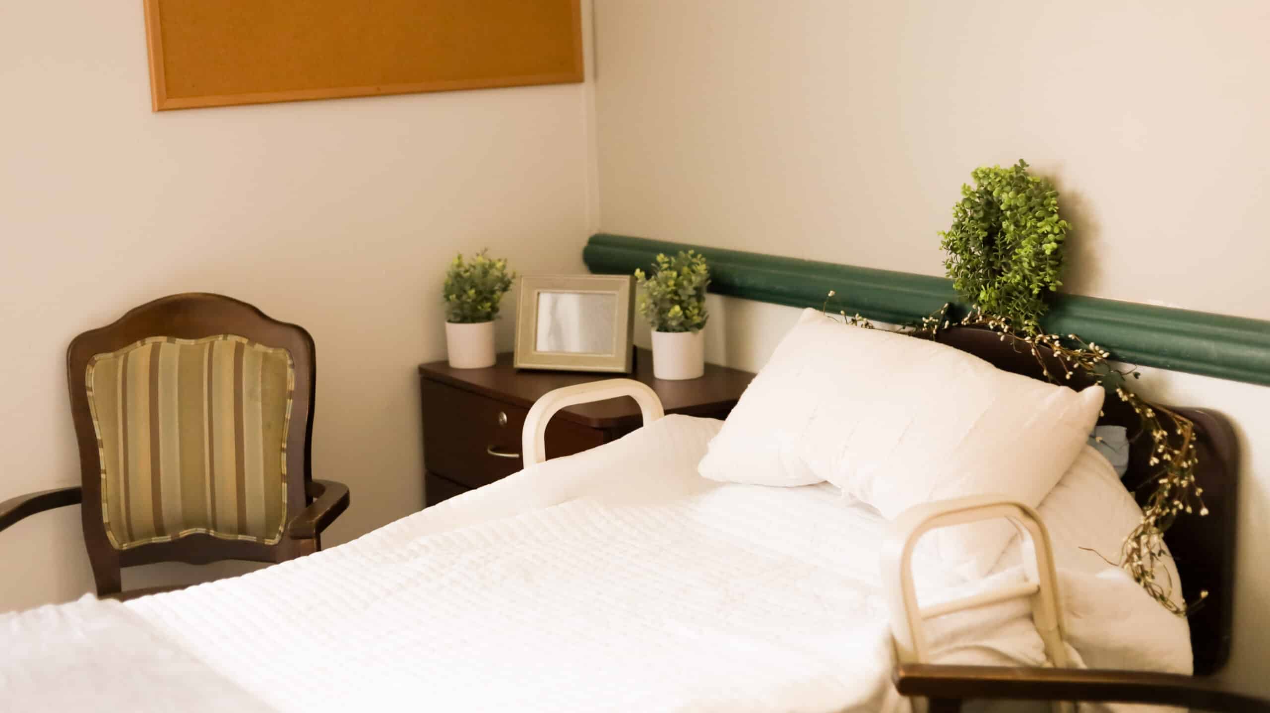 Bed with nightstand and a chair