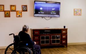 Resident watching TV on the wall