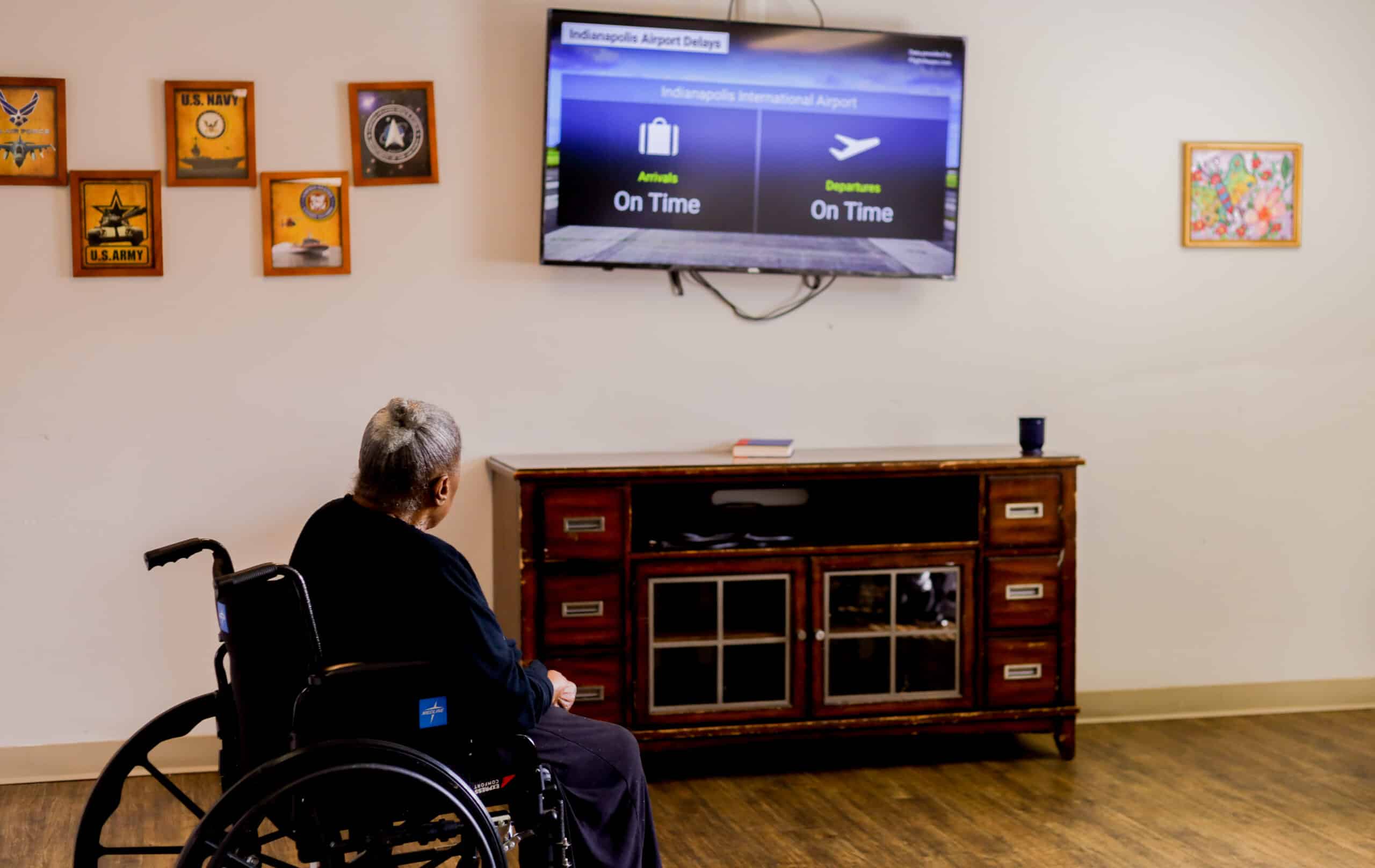 Resident watching TV on the wall