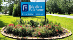 Sign of Edgefield Post Acute outside surrounded by flowers