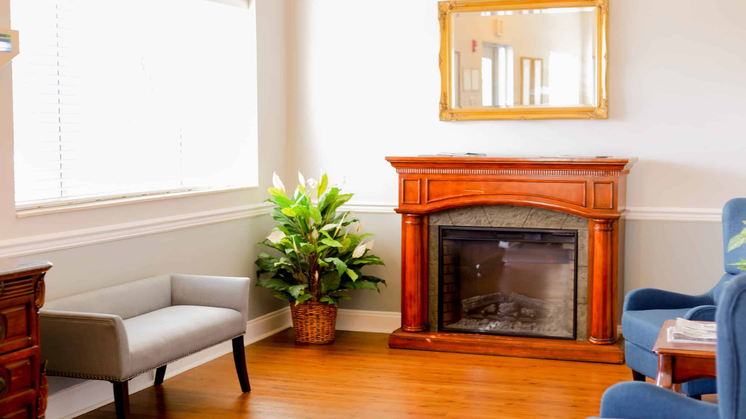 Waiting room at Edgefield Post Acute with seating and a fireplace