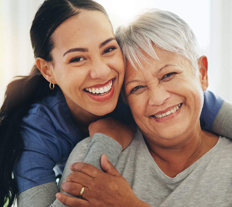 Happy woman, nurse and hug senior patient in elderly care, support or trust at old age home. Portrait of mature female person, doctor or medical caregiver hugging with smile for embrace at house